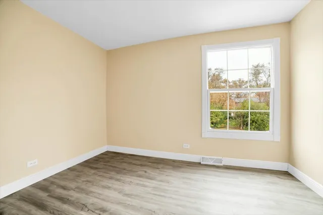 a view of a room with wooden floor