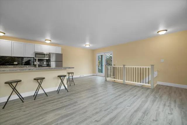 a view of kitchen with furniture and wooden floor