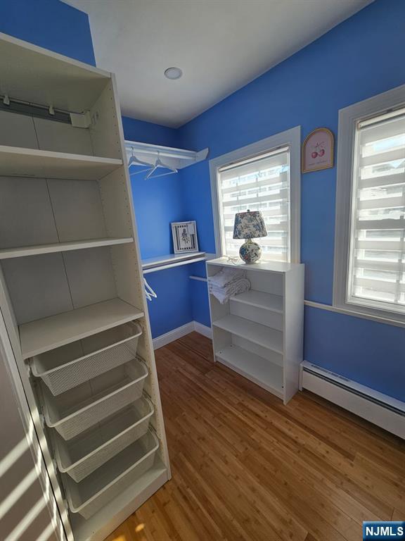 29 Willard Street, Unit 2 Garfield, NJ 07026 - Photo 13 of 21 a view of walk in closet with wooden floor and cabinet