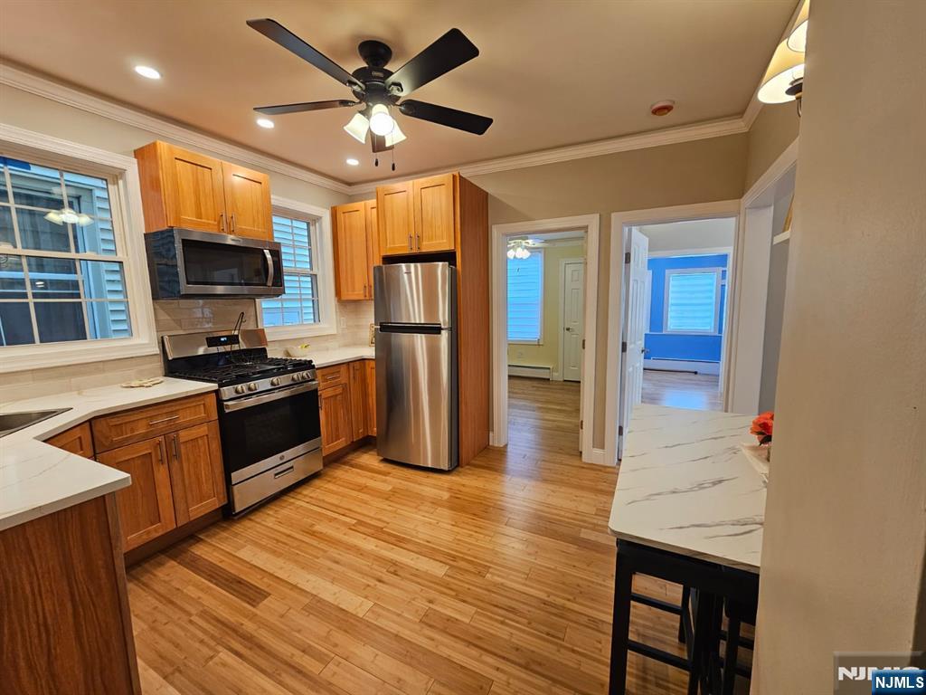 29 Willard Street, Unit 2 Garfield, NJ 07026 - Photo 2 of 21 a kitchen with stainless steel appliances granite countertop a stove refrigerator sink and microwave