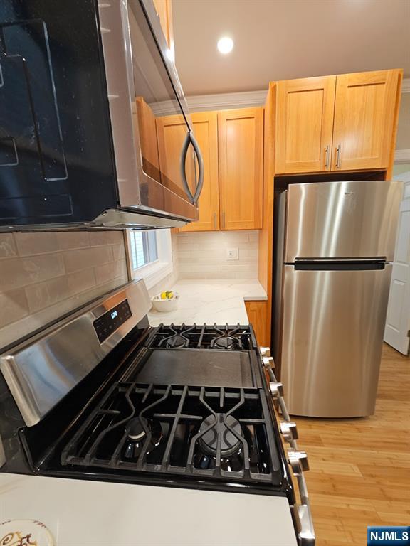 29 Willard Street, Unit 2 Garfield, NJ 07026 - Photo 4 of 21 a kitchen with wooden cabinets and a stove top oven