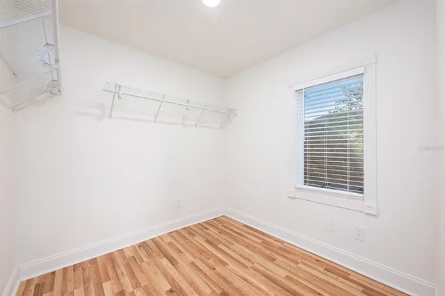 a view of a room with wooden floor and fan