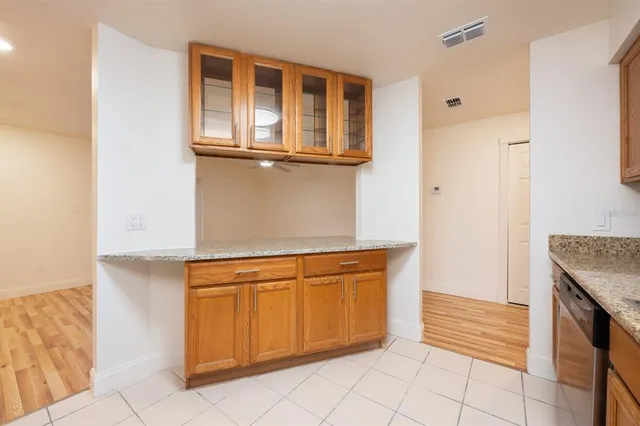a view of a kitchen with white cabinets