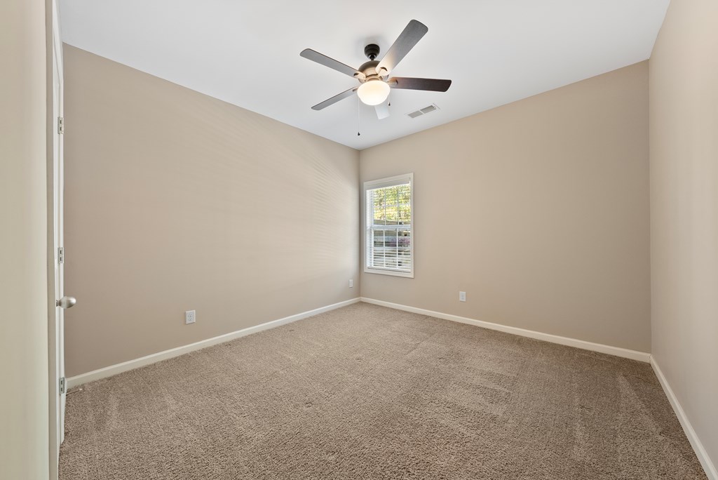 67 Pin Oak Way Hamilton, GA 31811 - Photo 23 of 65 an empty room with windows and fan