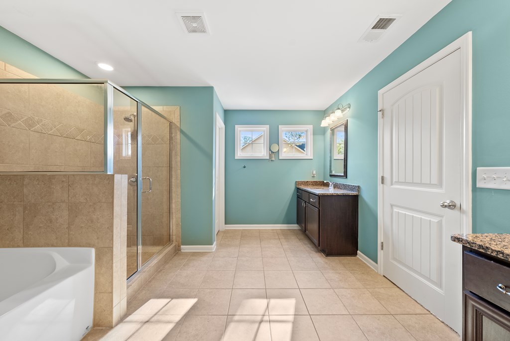 67 Pin Oak Way Hamilton, GA 31811 - Photo 31 of 65 a bathroom with a granite countertop sink a mirror and a bathtub