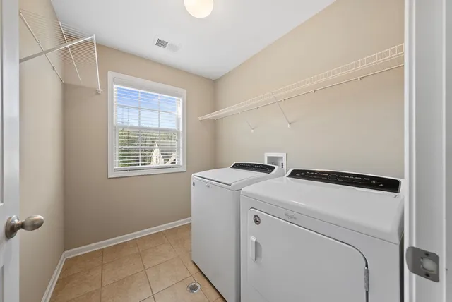 a view of backyard with large trees and wooden fence