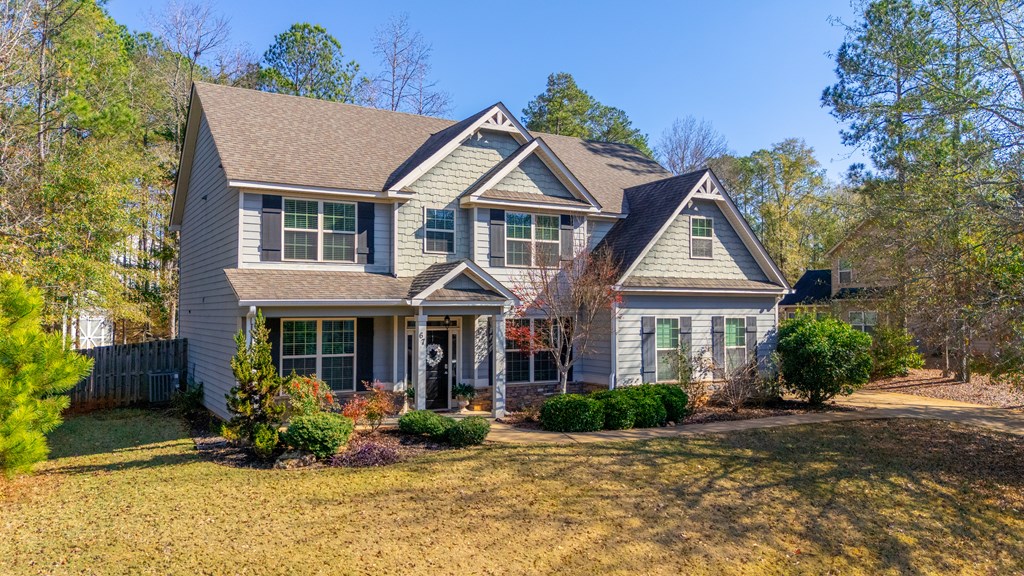 67 Pin Oak Way Hamilton, GA 31811 - Photo 61 of 65 a front view of a house with a yard and potted plants