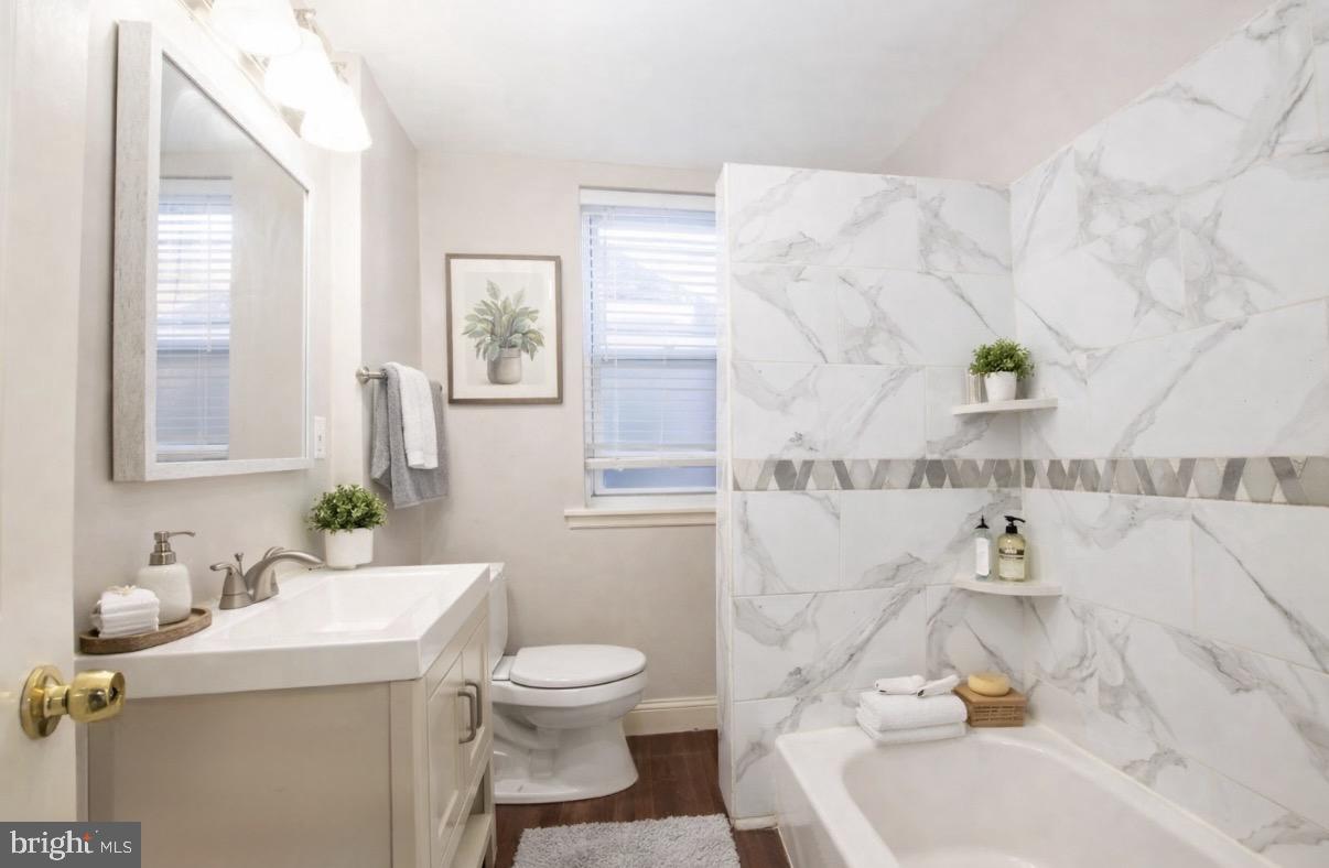 2707 Morris Street Philadelphia, PA 19145 - Photo 13 of 26 a bathroom with a sink toilet and window