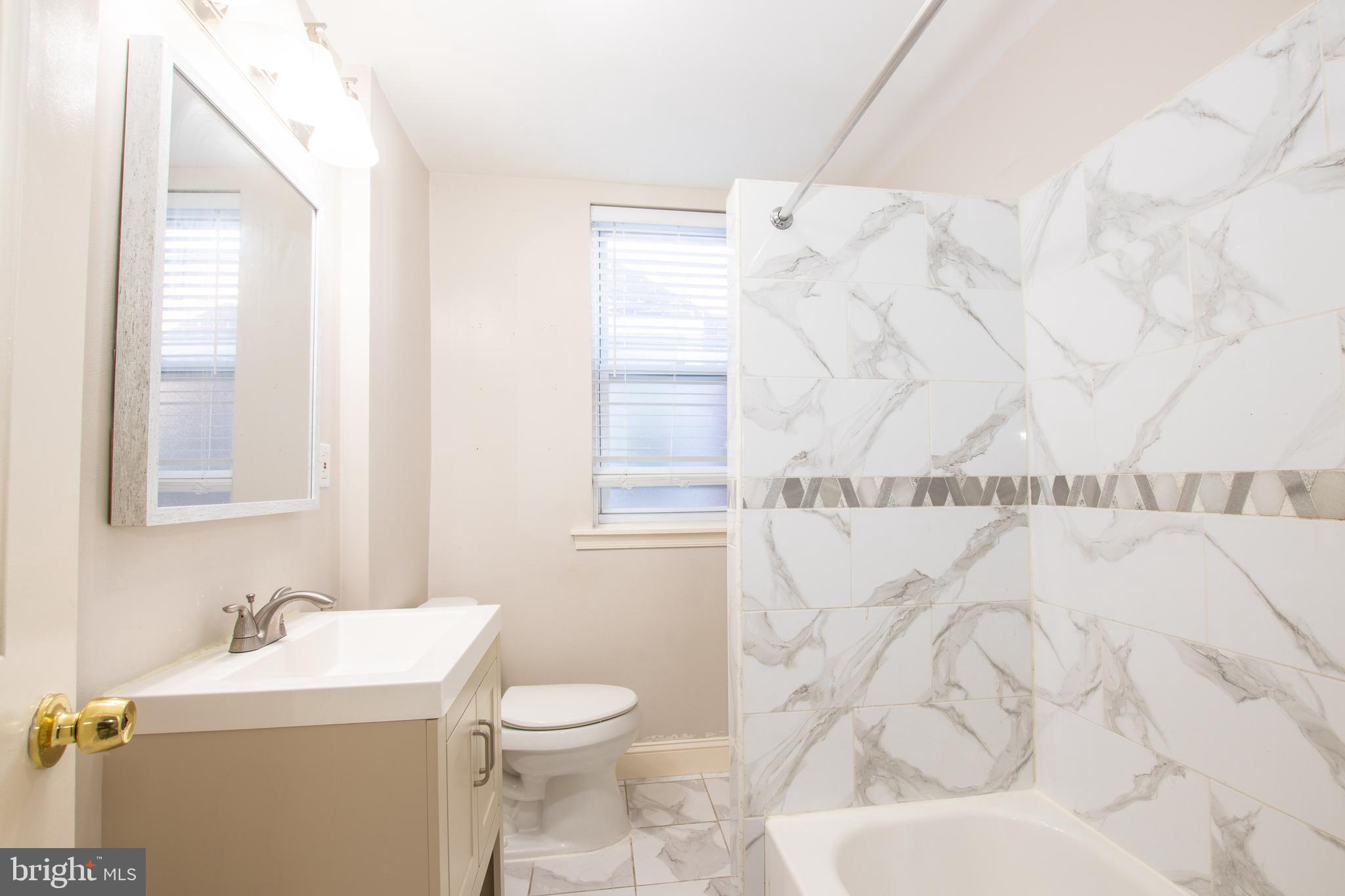 2707 Morris Street Philadelphia, PA 19145 - Photo 14 of 26 a bathroom with a sink toilet and window