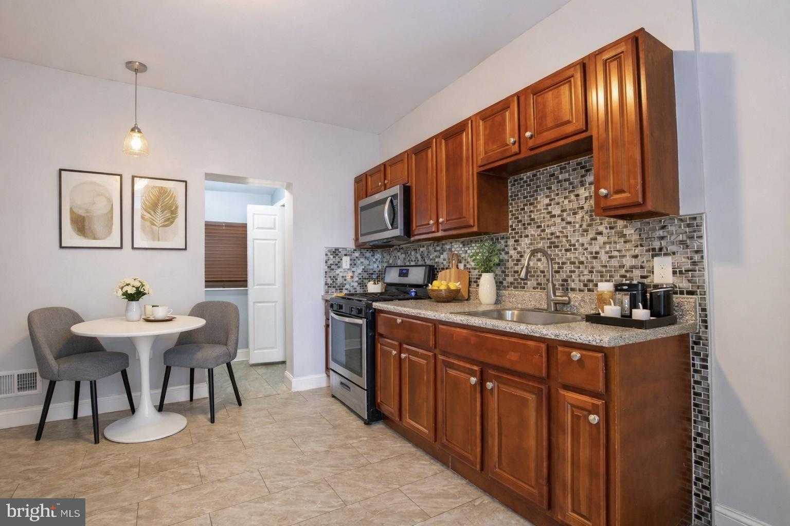 2707 Morris Street Philadelphia, PA 19145 - Photo 6 of 26 a kitchen with granite countertop a sink cabinets and appliances