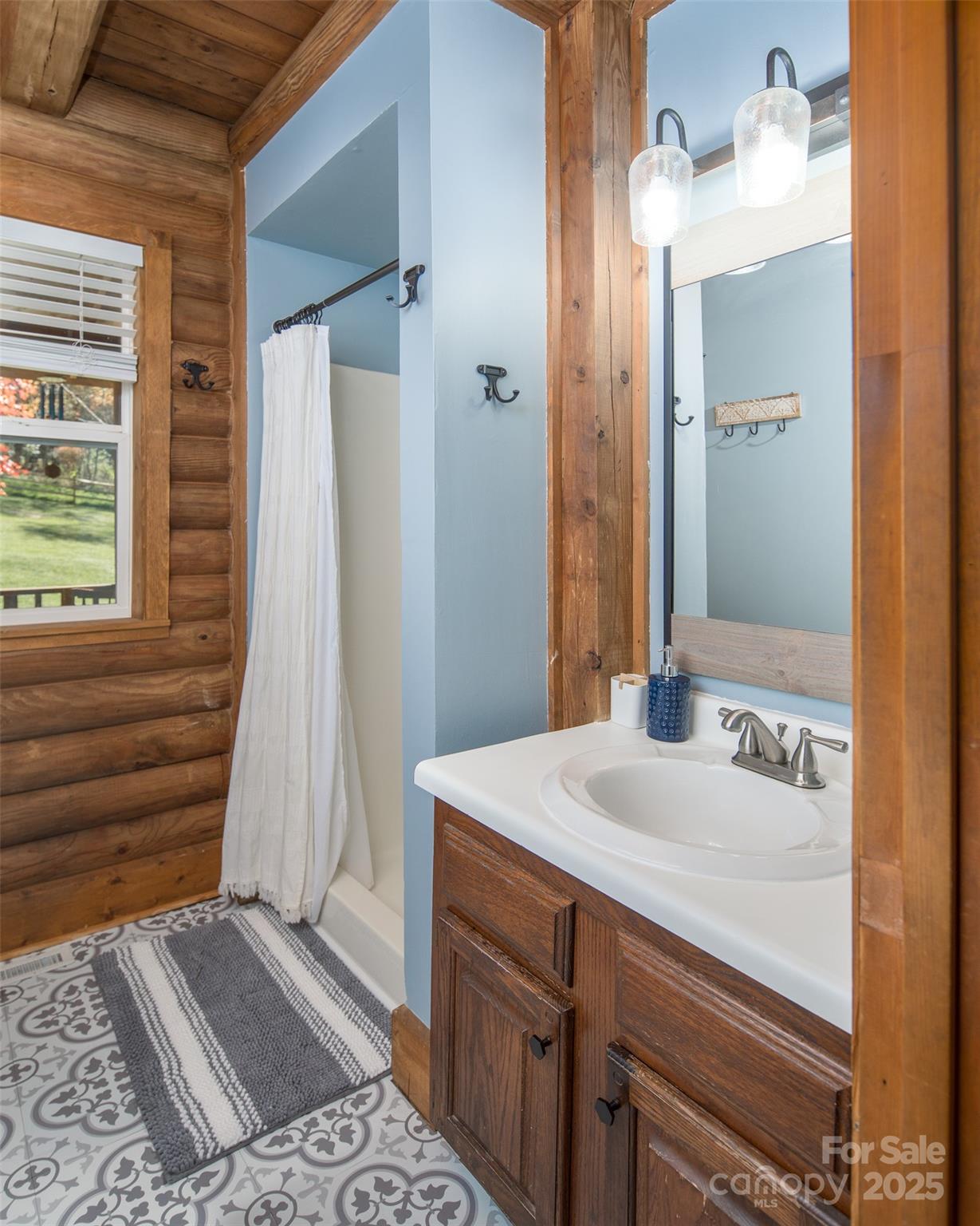 1090 Horse Bottom Road Banner Elk, NC 28604 - Photo 16 of 30 a bathroom with a sink and a mirror