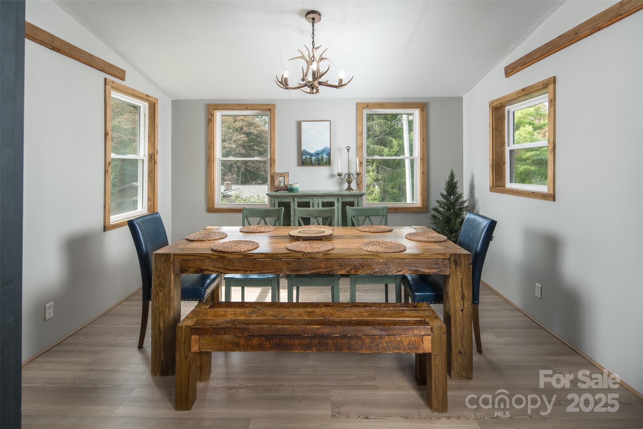 1090 Horse Bottom Road Banner Elk, NC 28604 - Photo 10 of 30 a view of a dining room with furniture window and wooden floor