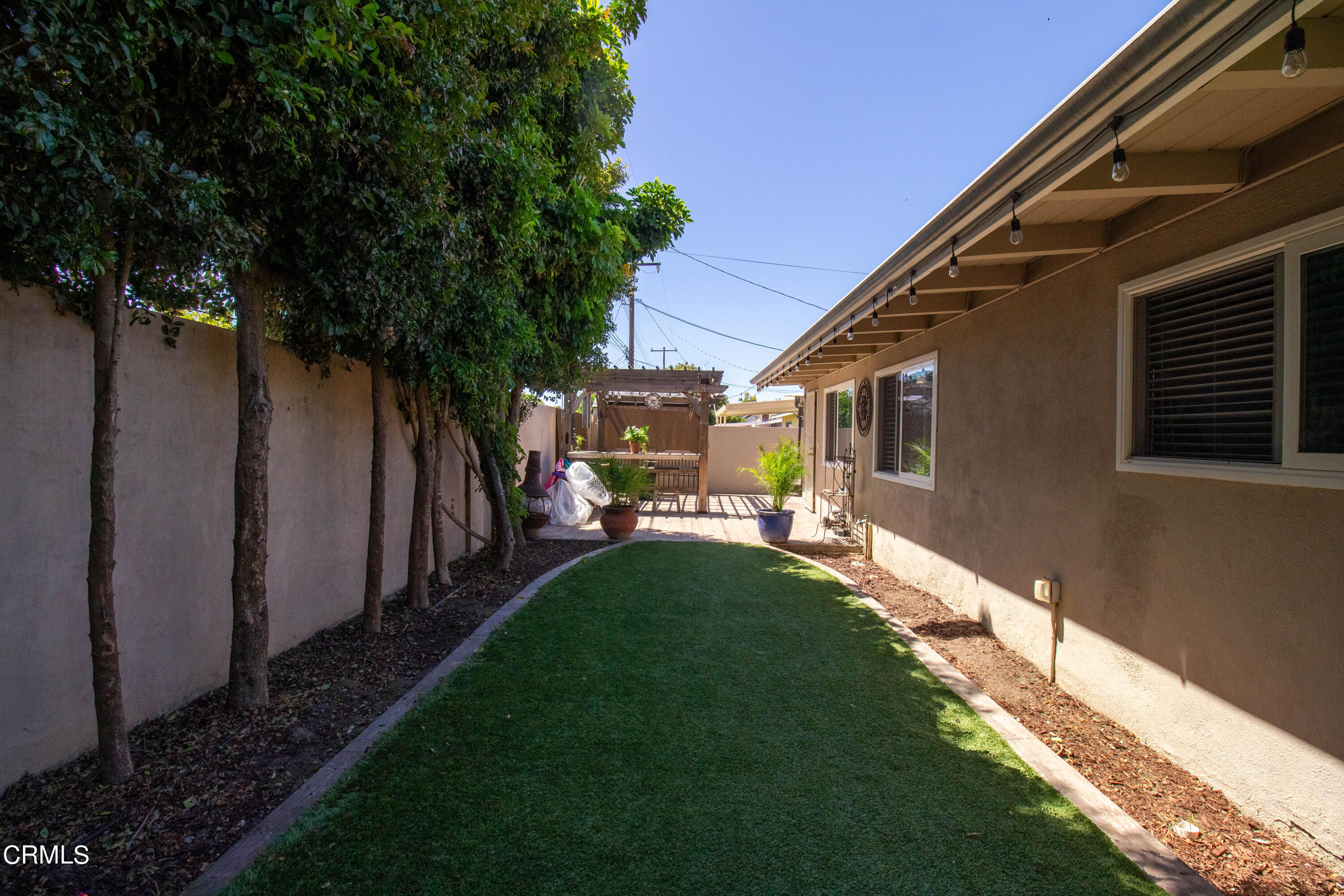 1300 Bluebell Street Oxnard, CA 93036 - Photo 17 of 24 a backyard of a house with table and chairs and potted plants