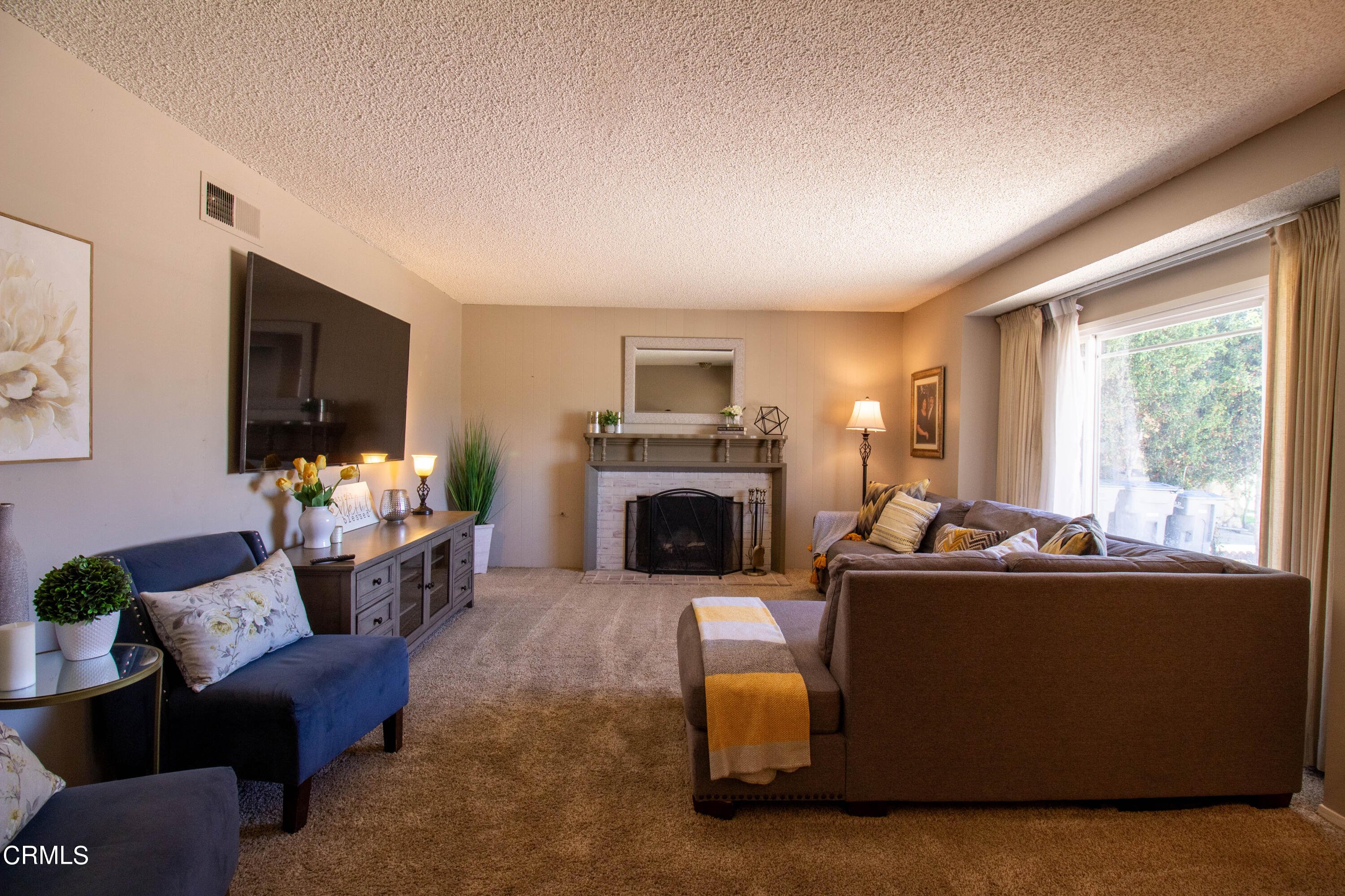 1300 Bluebell Street Oxnard, CA 93036 - Photo 3 of 24 a living room with furniture fireplace and flat screen tv