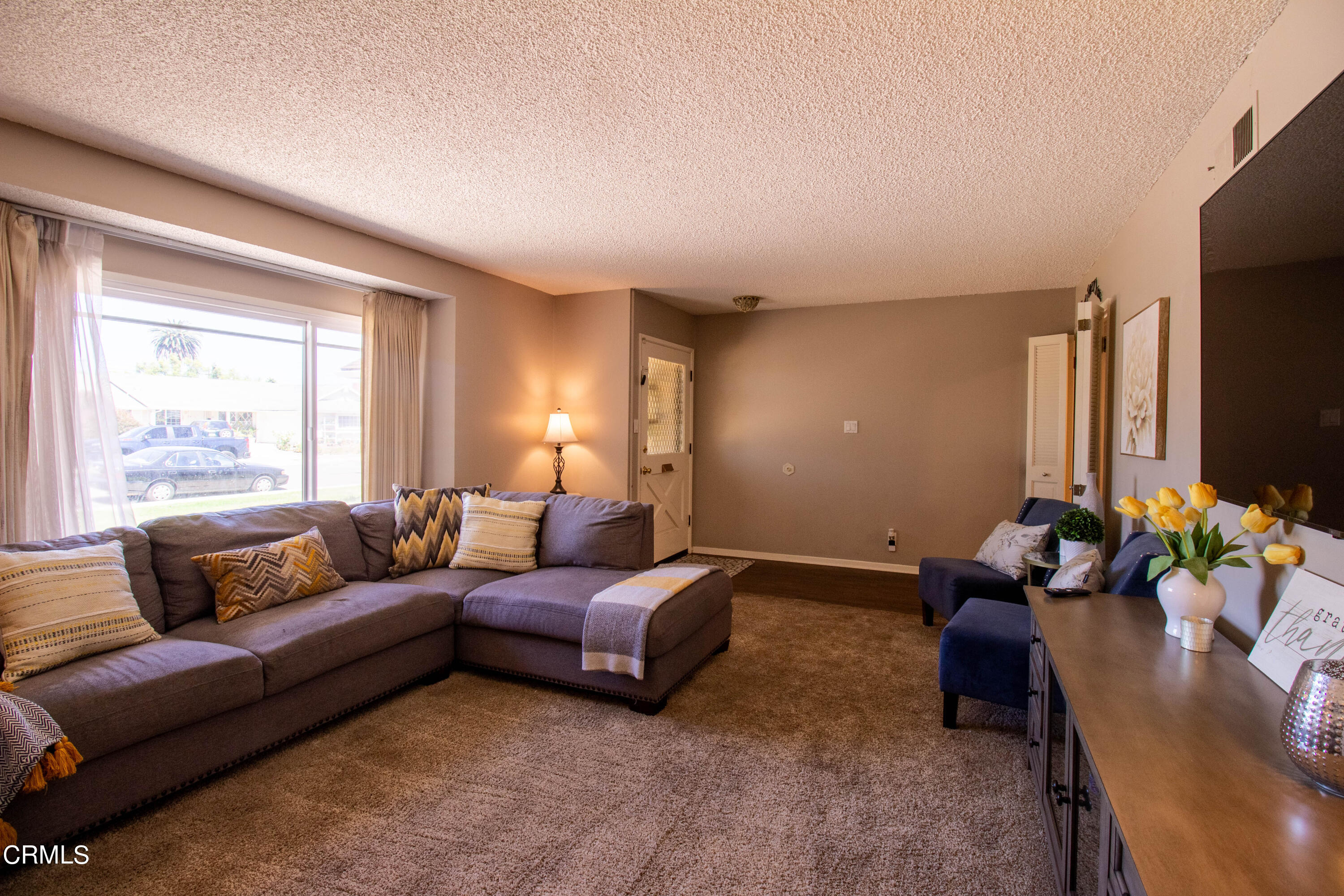 1300 Bluebell Street Oxnard, CA 93036 - Photo 4 of 24 a living room with furniture fireplace and a flat screen tv