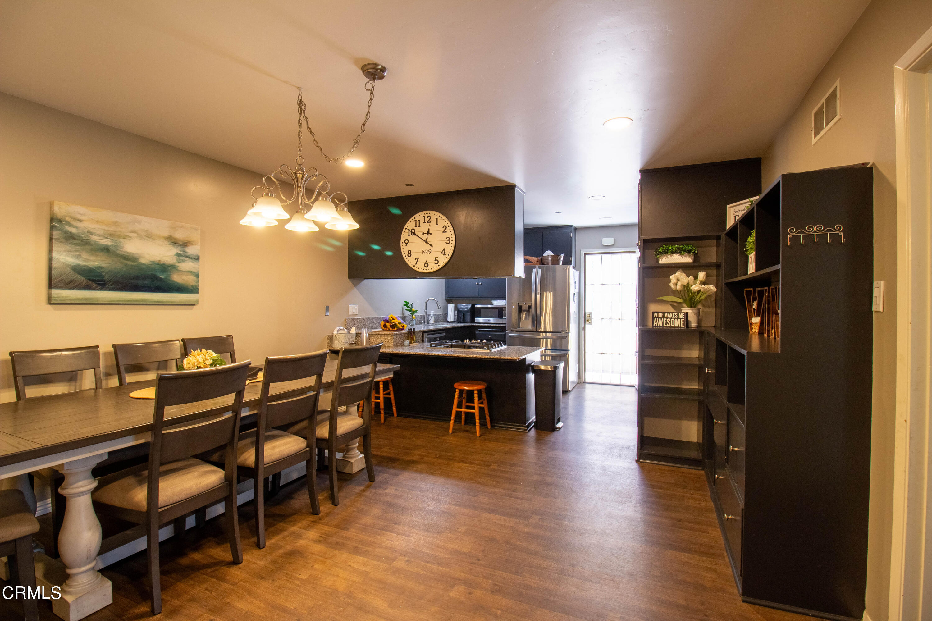1300 Bluebell Street Oxnard, CA 93036 - Photo 5 of 24 a view of a dining room with furniture and wooden floor