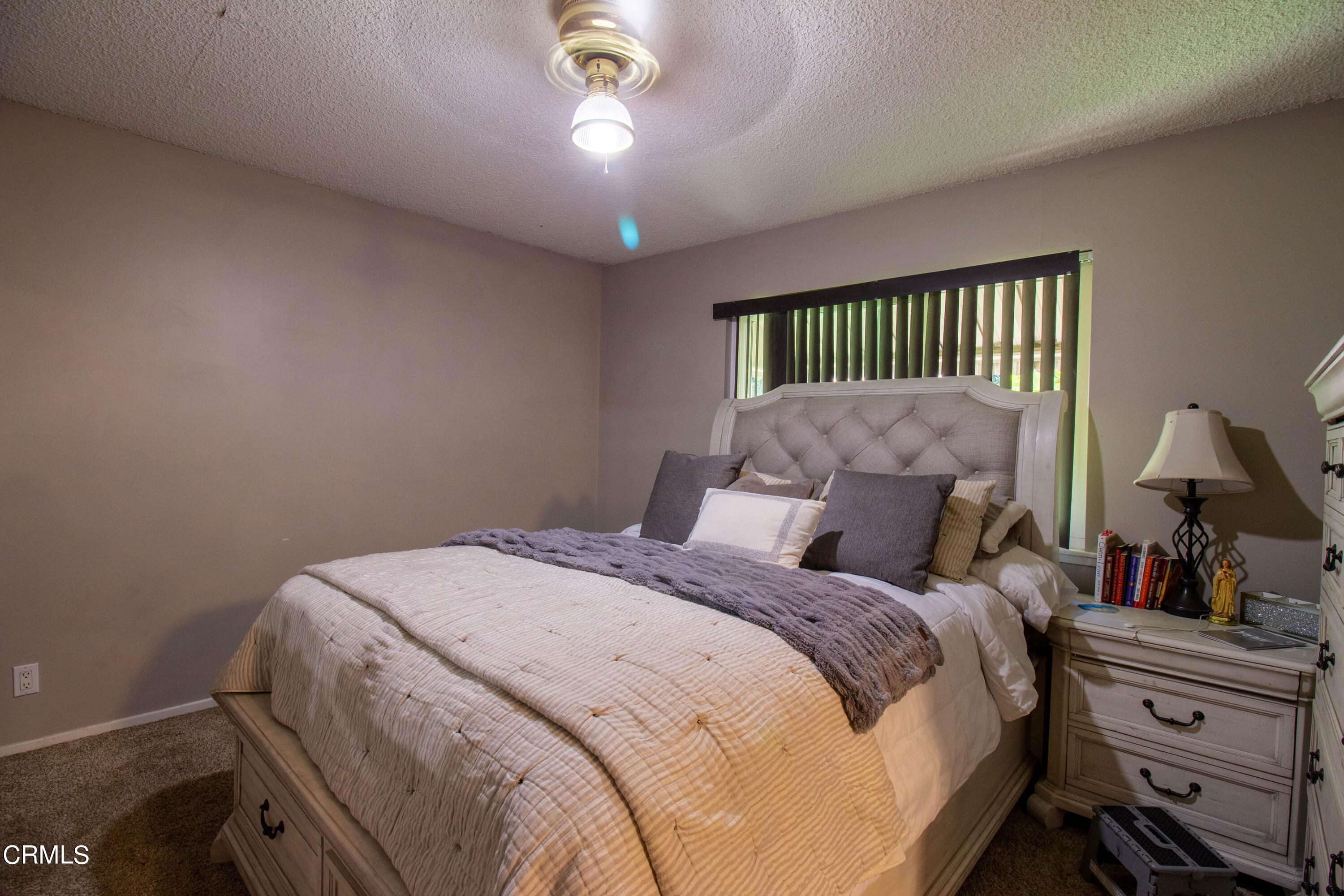 1300 Bluebell Street Oxnard, CA 93036 - Photo 10 of 24 a bedroom with a bed and a chandelier