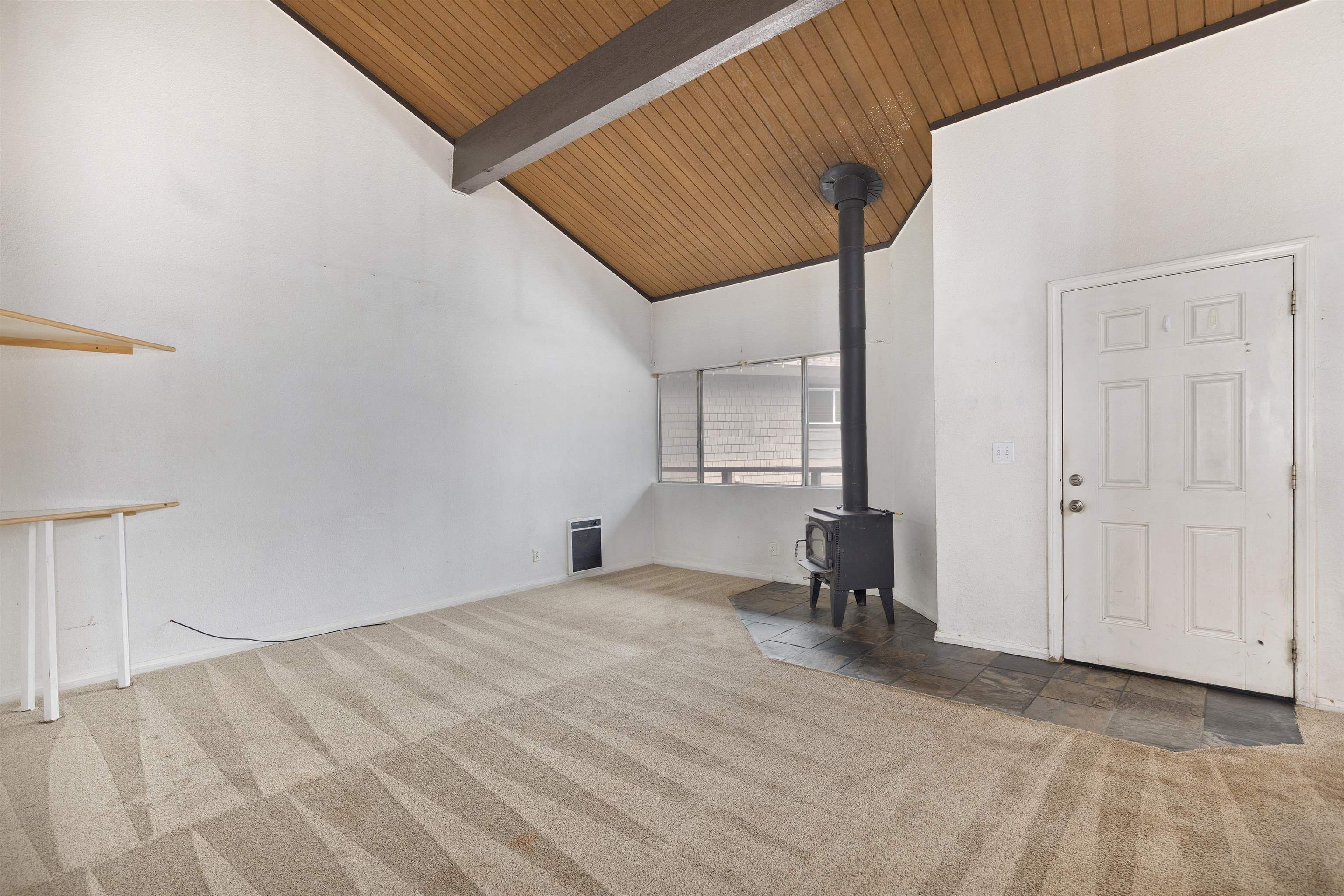 165 Old Mammoth Road, Unit 132 Mammoth Lakes, CA 93546 - Photo 10 of 26 a view of a livingroom with a chair and the door