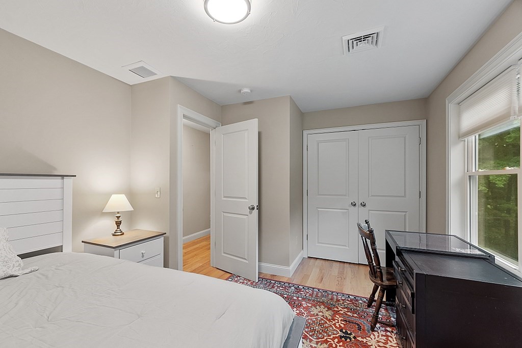 24 Little Turnpike Road Shirley, MA 01464 - Photo 18 of 42 a bedroom with a bed and a table in it