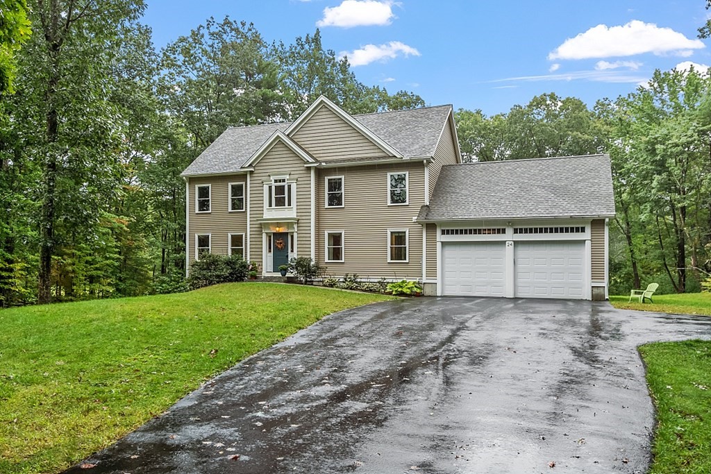 24 Little Turnpike Road Shirley, MA 01464 - Photo 2 of 42 a front view of a house with a yard and garage