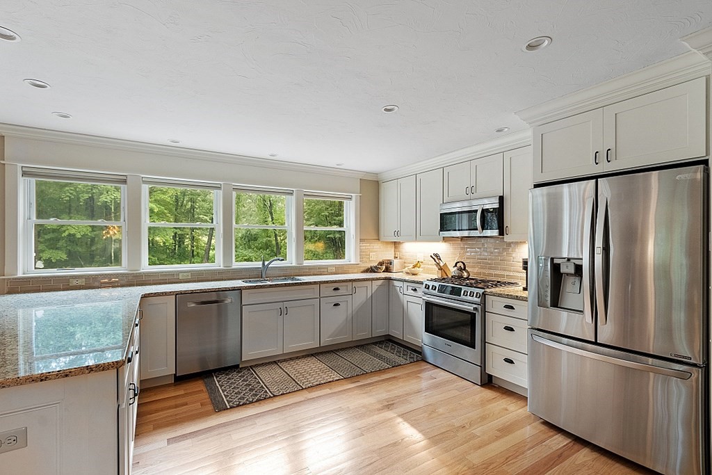 24 Little Turnpike Road Shirley, MA 01464 - Photo 30 of 42 a kitchen with granite countertop stainless steel appliances a refrigerator sink and microwave