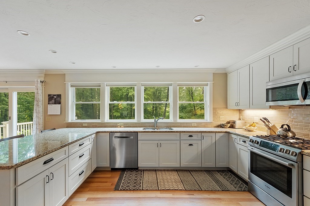24 Little Turnpike Road Shirley, MA 01464 - Photo 31 of 42 a large kitchen with granite countertop a stove a sink dishwasher a refrigerator and a microwave oven