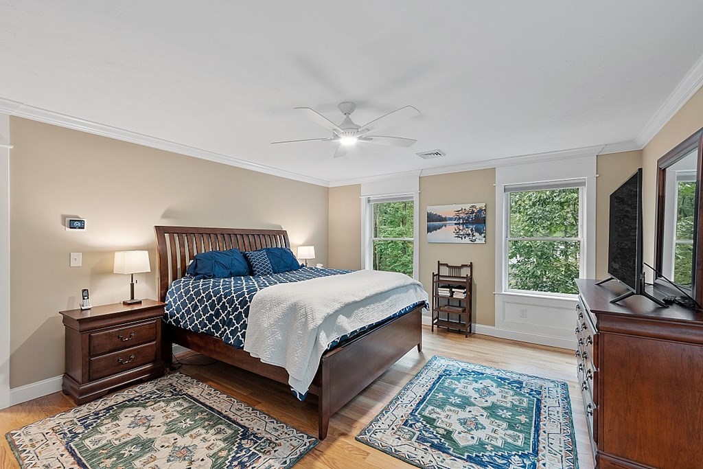 24 Little Turnpike Road Shirley, MA 01464 - Photo 10 of 42 a bedroom with a large bed a flat tv screen and a dresser