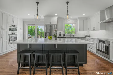 a kitchen with a table chairs stove and microwave