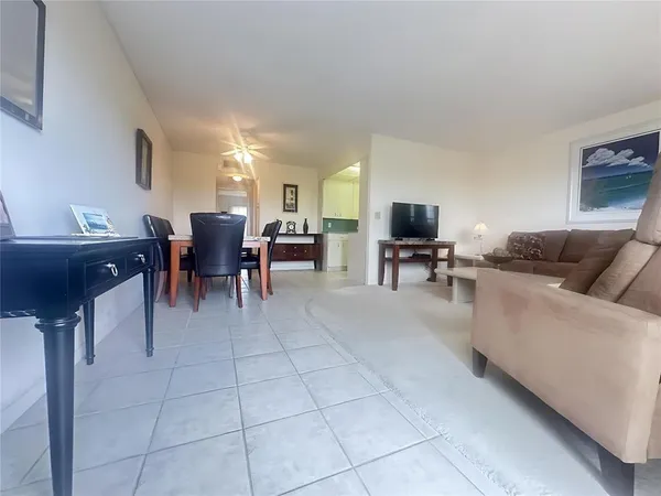 a living room with furniture a dining table and a piano table