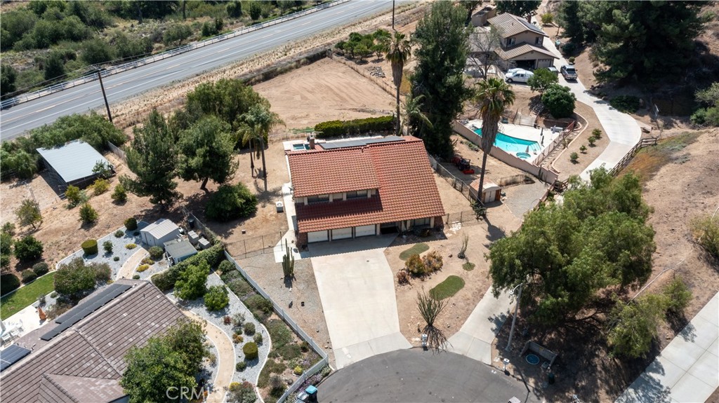 17656 Mockingbird Hill Circle Riverside, CA 92504 - Photo 39 of 49 an aerial view of a house with a yard and parking spaces