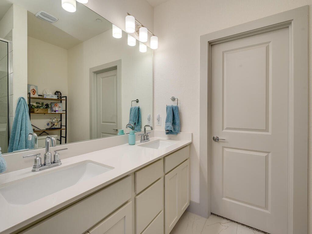 2257 Local Rebel Loop Leander, TX 78641 - Photo 17 of 26 a bathroom with a sink and a mirror