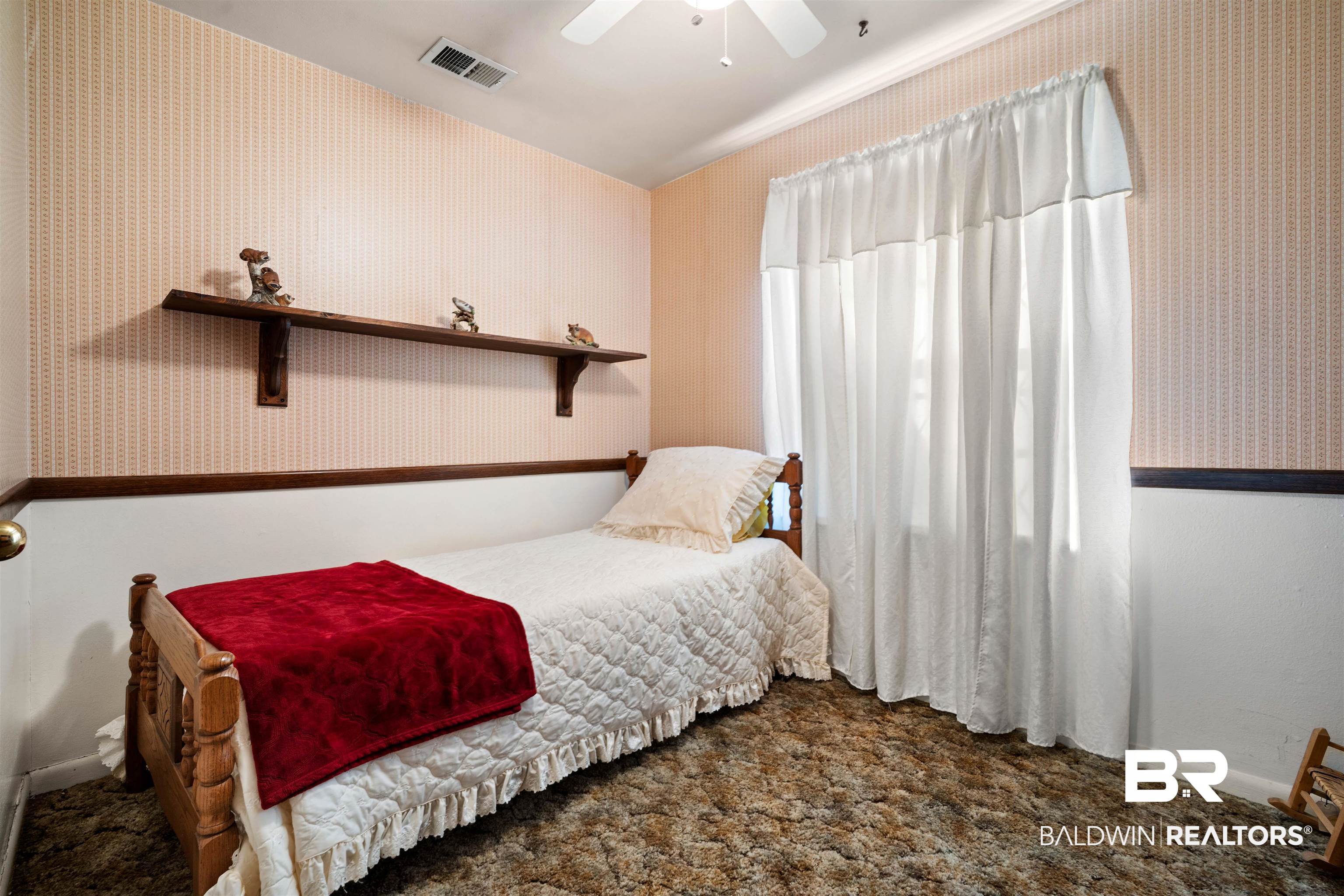2618 Serigny Drive Mobile, AL 36605 - Photo 20 of 25 Bedroom with wallpapered walls and a ceiling fan