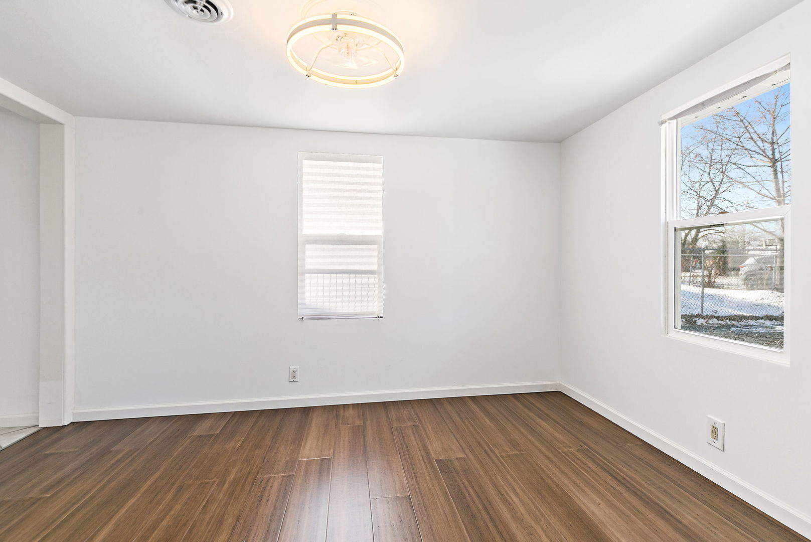 612 South Webster Street Aurora, IL 60505 - Photo 19 of 24 an empty room with wooden floor and windows