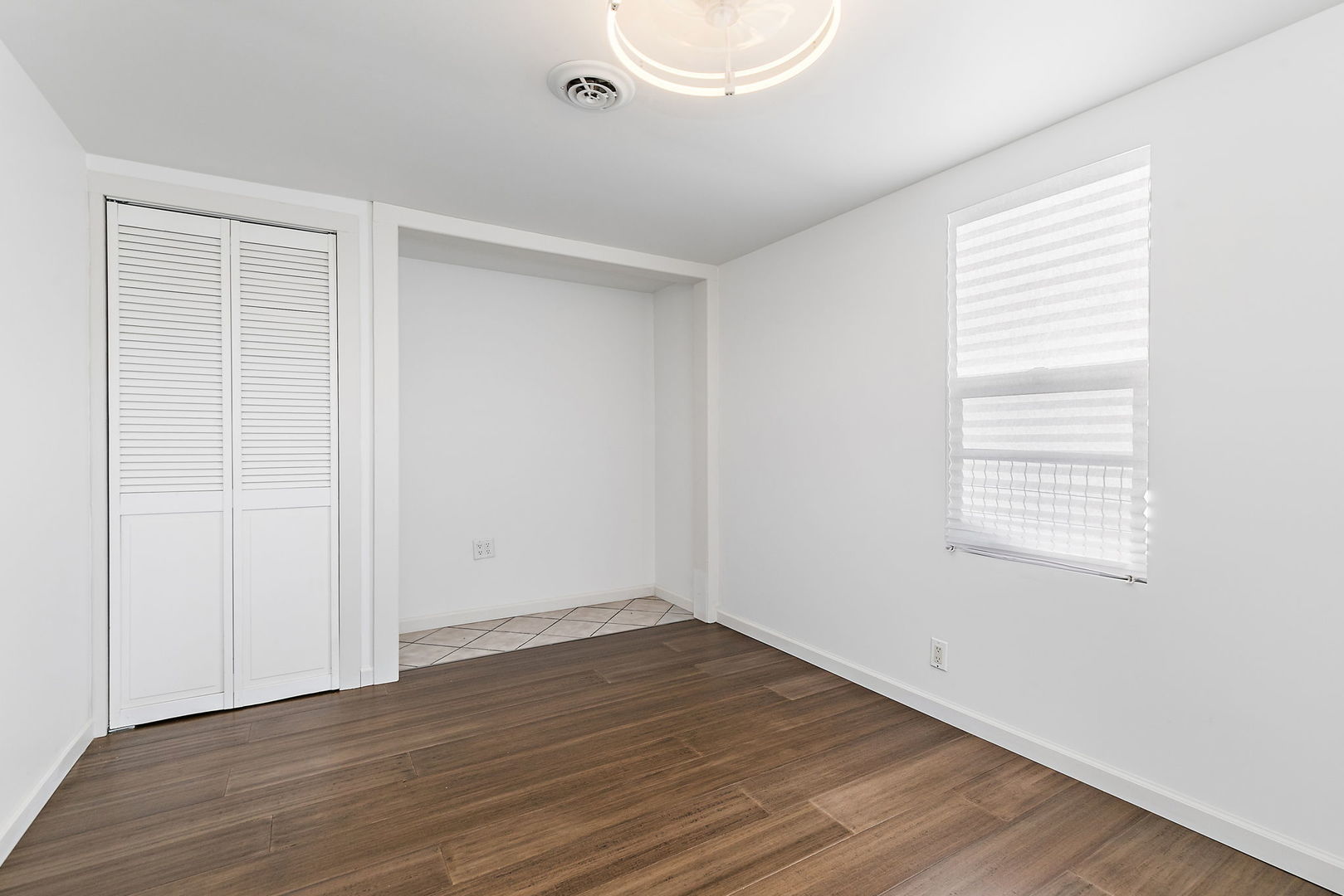 612 South Webster Street Aurora, IL 60505 - Photo 20 of 24 an empty room with wooden floor and windows