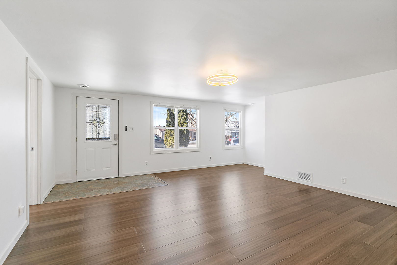 612 South Webster Street Aurora, IL 60505 - Photo 3 of 24 an empty room with wooden floor and windows