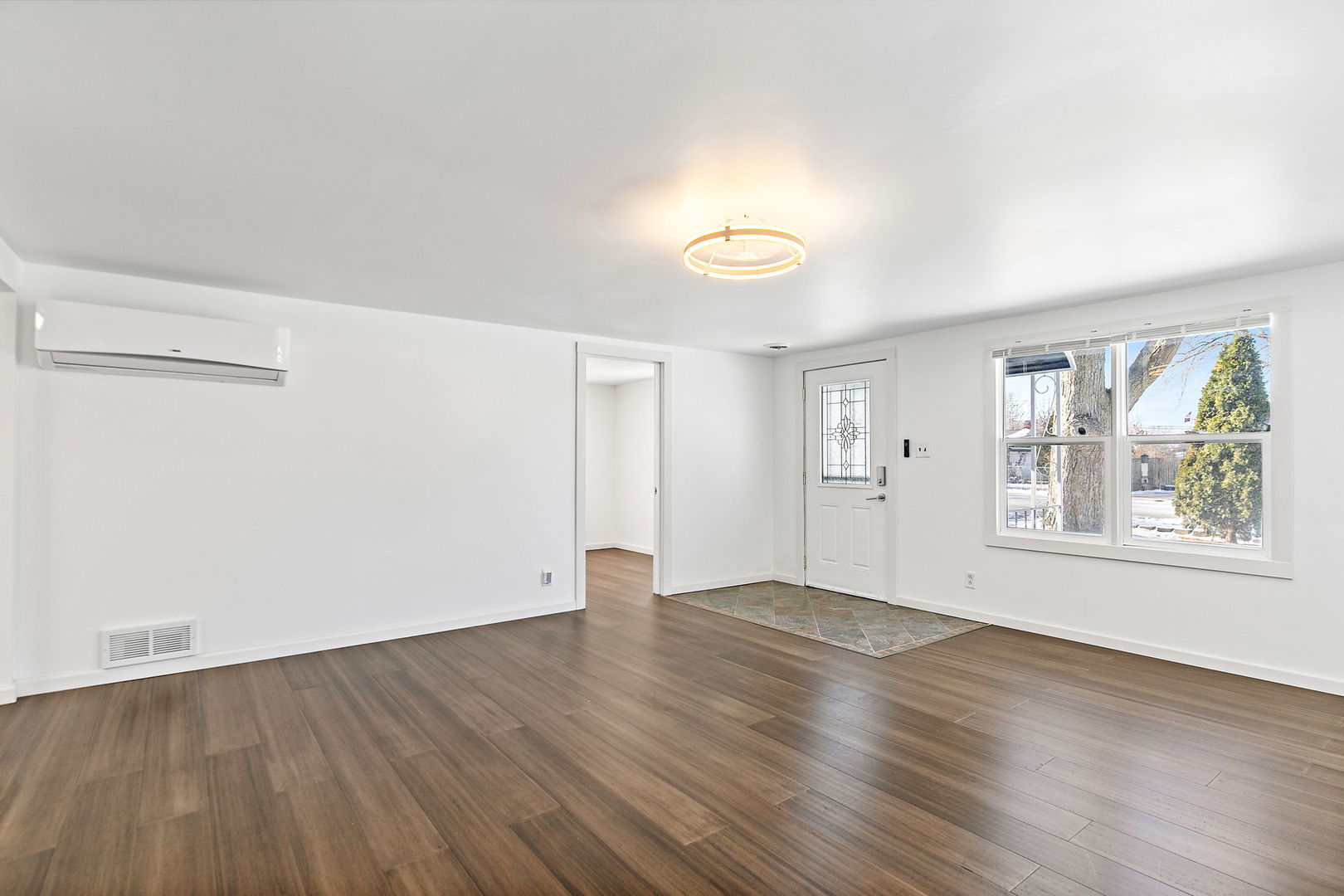 612 South Webster Street Aurora, IL 60505 - Photo 6 of 24 an empty room with wooden floor and windows