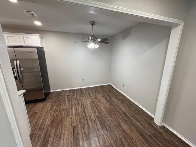 wooden floor in an empty room with a mirror