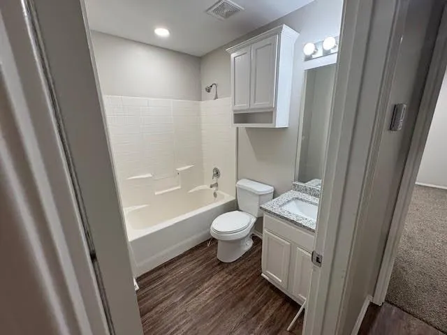 a bathroom with a toilet a sink and bathtub