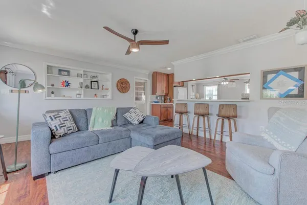 a living room with furniture and a wooden floor