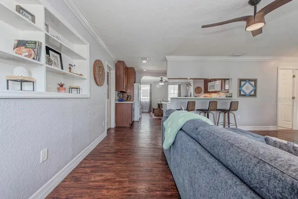 a living room with furniture and a wooden floor