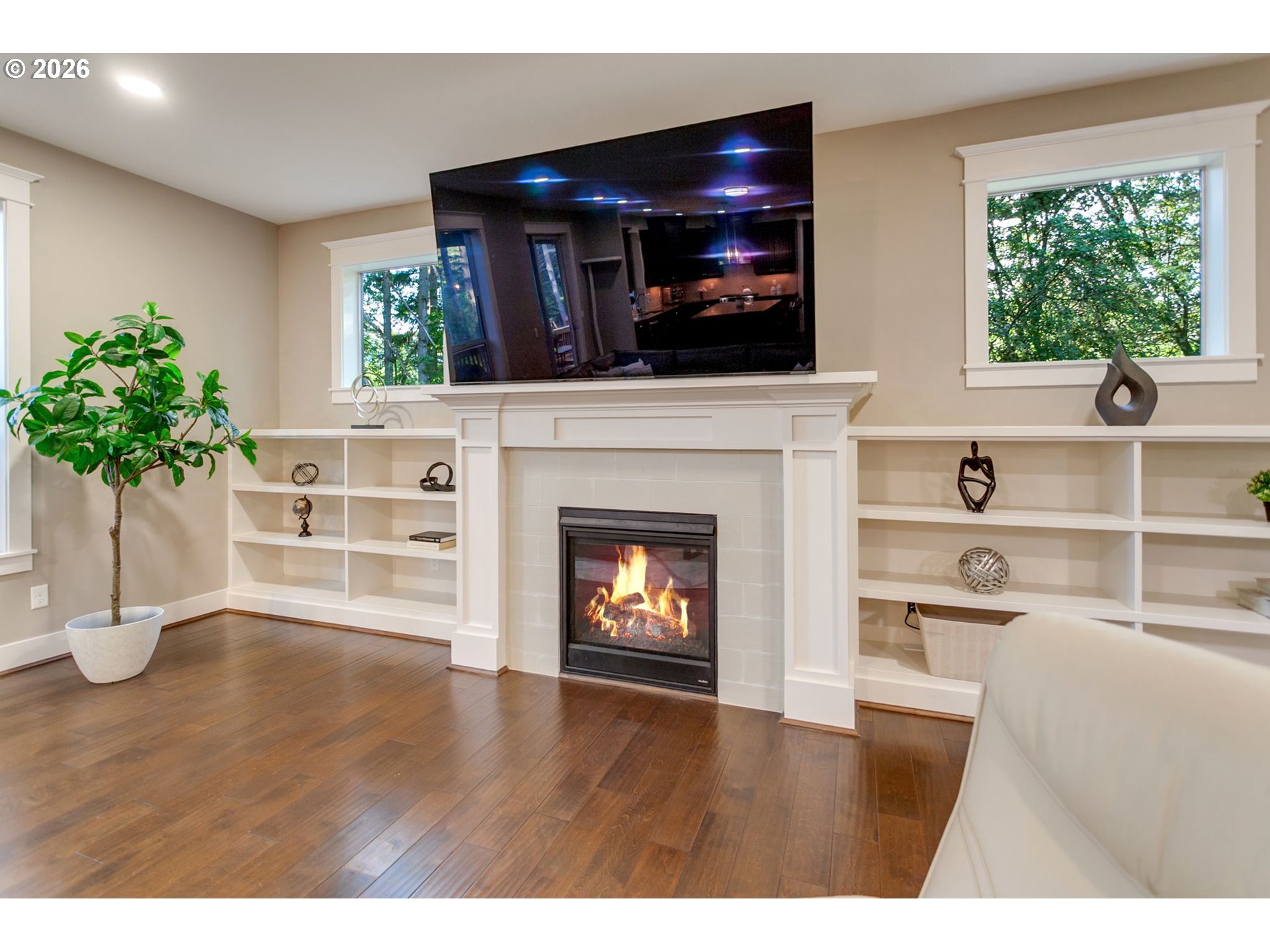 14390 Southwest Fox Lane Beaverton, OR 97008 - Photo 7 of 47 a living room with a fireplace and potted plants