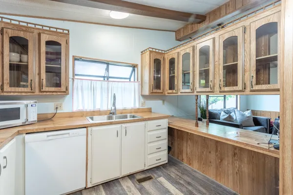 a kitchen with stainless steel appliances granite countertop a sink stove and cabinets