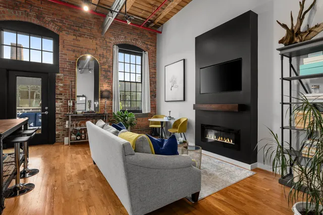a living room with furniture and a fireplace