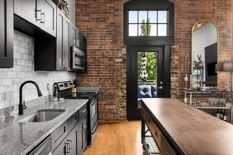 a kitchen with a sink a stove and cabinets