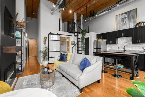 a living room with furniture and a fireplace