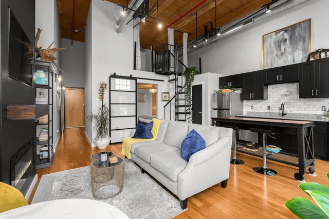 a living room with furniture and a fireplace