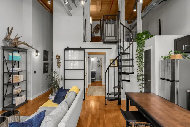 a living room with furniture a fireplace and wooden floor