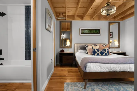 a bedroom with a bed and a chandelier