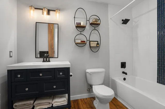 a bathroom with a toilet sink and mirror