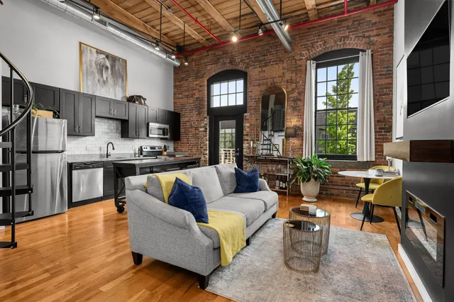 a living room with furniture fireplace and flat screen tv